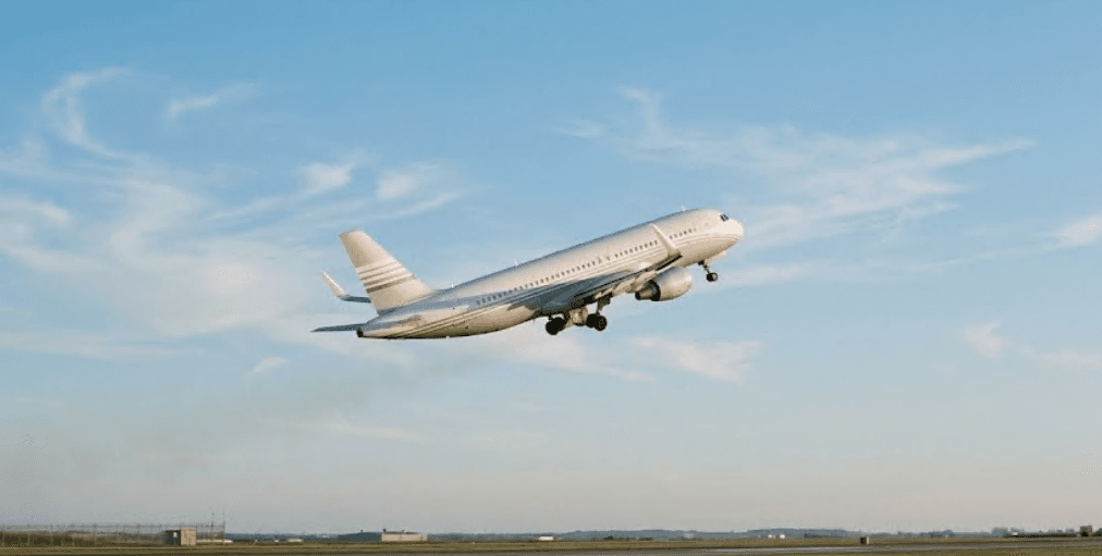 An airliner climbing into a clear sky.