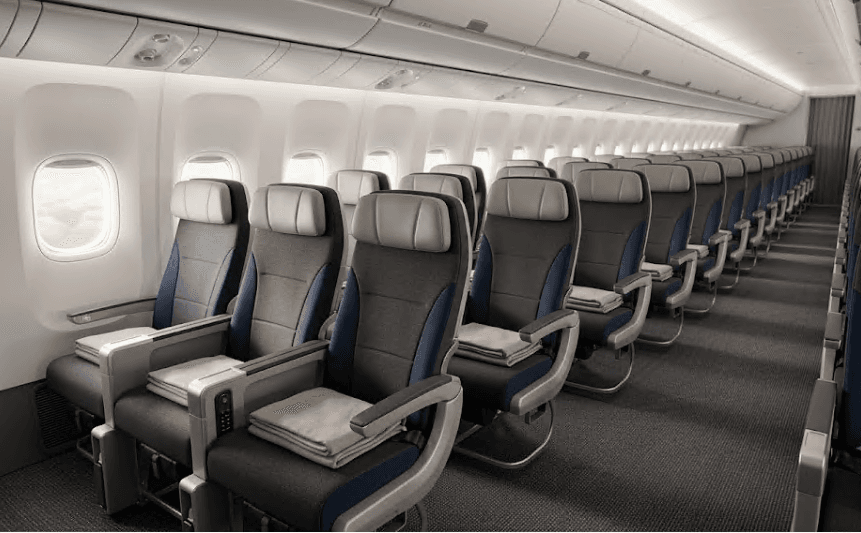 Rows of empty seats inside an aircraft cabin.