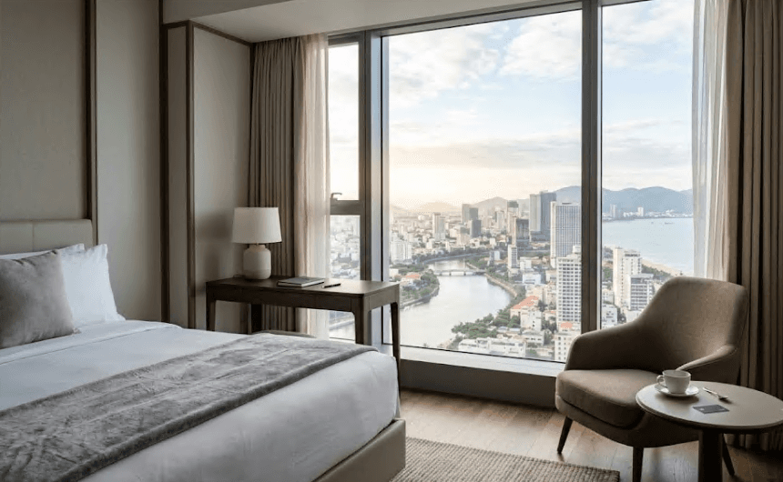 A tidy hotel room with a view through the window.