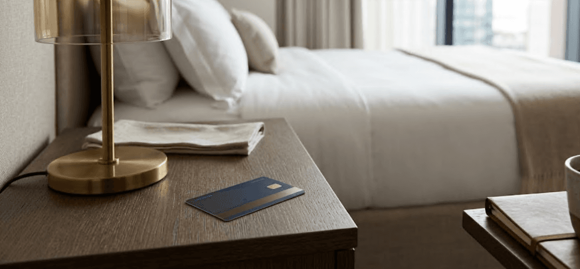 A hotel key card resting on a bedside table.